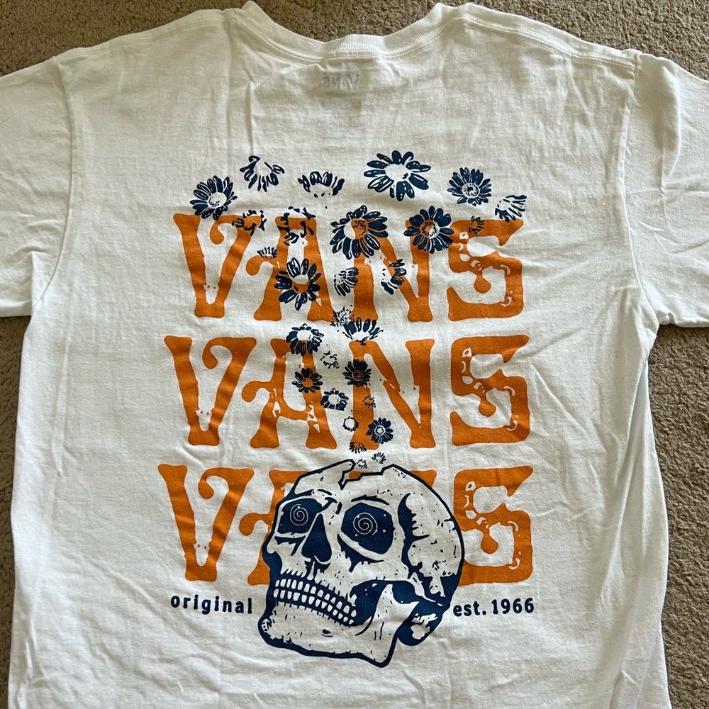 White unisex Vans T-shirt with blue and orange floral skull print.